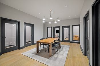 a dining room with a wooden table and chairs
